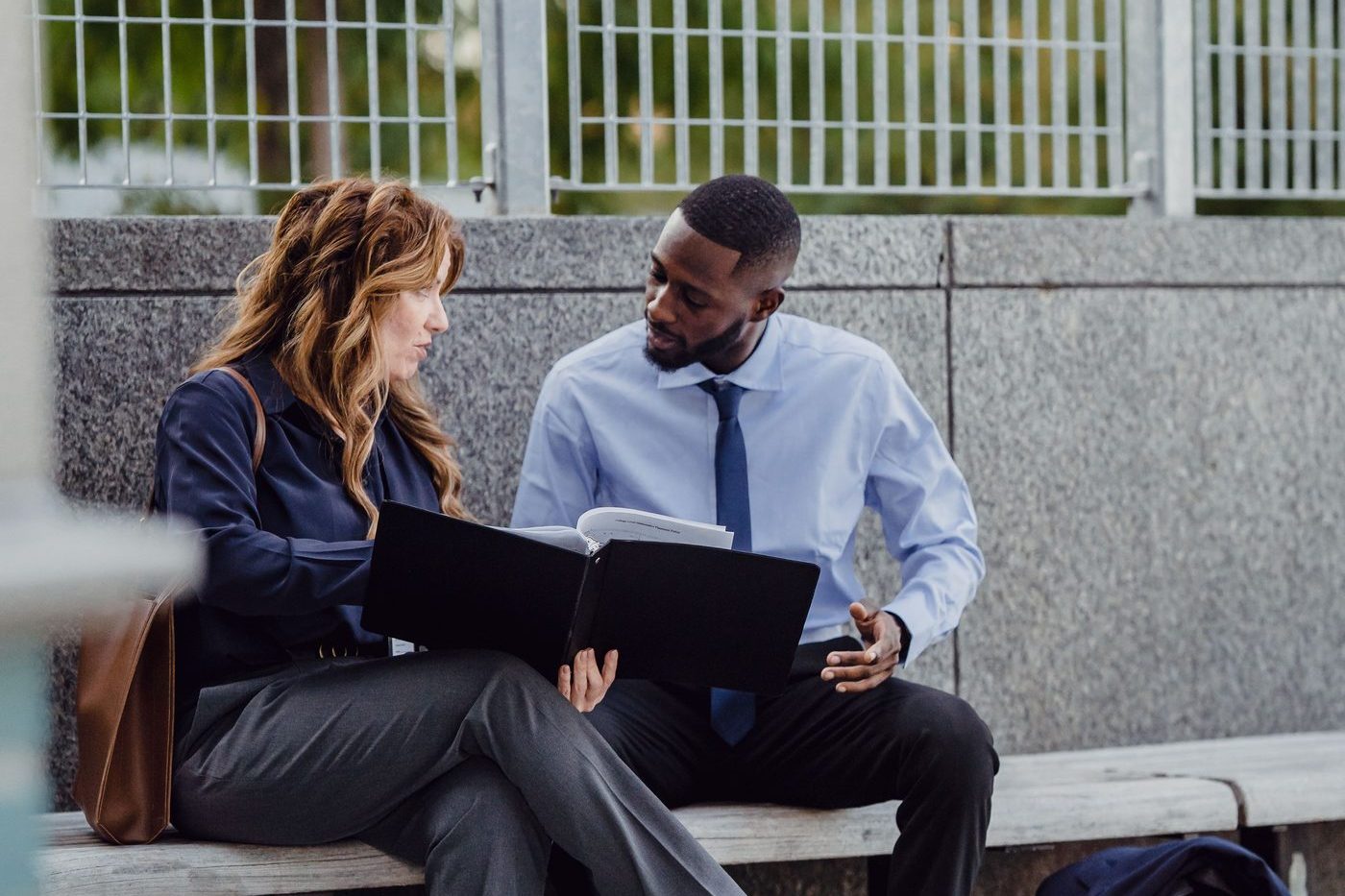 Two professionals reviewing a benefits document together