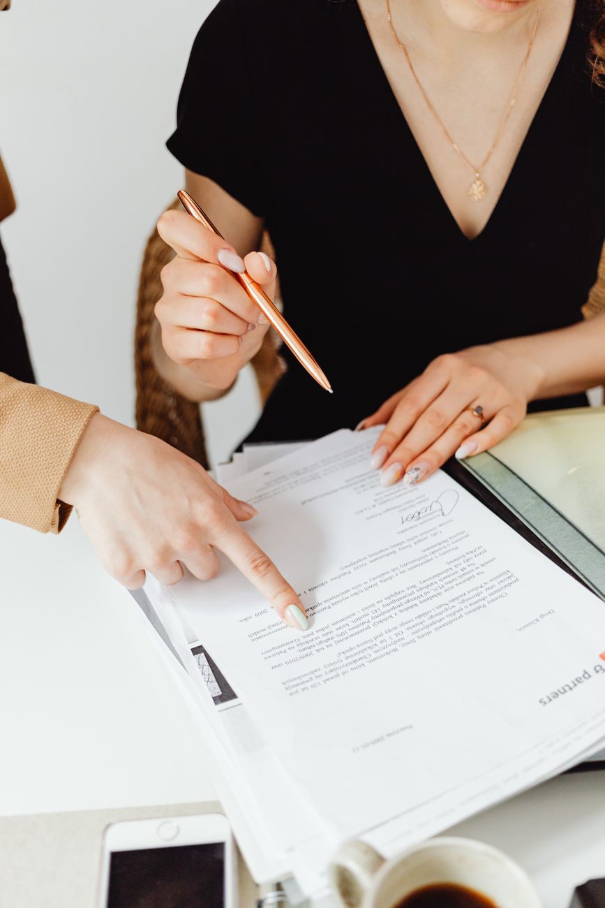 Two people going through a document together at a desk