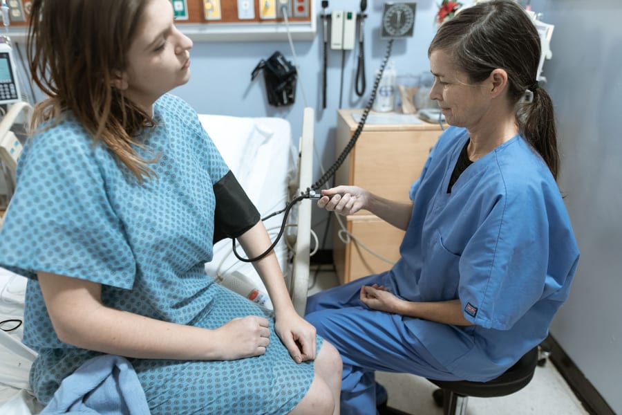 A nurse taking a patient's blood pressure